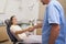 Dentist shaking hands with his patient in the chair