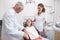 Dentist shaking hands with his patient in the chair