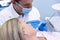 Dentist showing equipment to patient at medical clinic