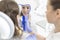 Dentist showing mirror to smiling girl patient at dental clinic