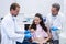 Dentist showing model teeth to patient