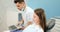 Dentist showing photo of teeth on a laptop for a young patient