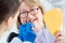 Dentist showing senior patient samples of teeth colors