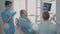 Dentist showing teeth radiography to patient on dental chair