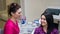 Dentist smiling and talking to female patient