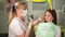 Dentist talking with young patient. Young girl attending dentist.