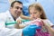 Dentist teaching girl how to properly brush her teeth