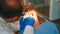 Dentist technician lighting the lamp for examining patient