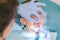 Dentist is treating a boy& x27;s teeth. A small patient in the dental chair smiles. Dantist treats teeth. close up view of dentist
