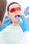Dentist uses photopolymer lamp to treat teeth