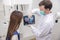 A dentist uses a tablet to show a patient her x-ray