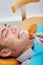 Dentist using dental curing light