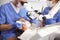 Dentist using dental microscope and examining woman`s teeth