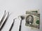 dentist utensils for oral review and american banknote of five dollar