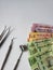 dentist utensils for oral review and mexican banknotes