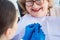 Dentist woman performing dental bleaching at senior patient