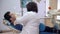 Dentist woman treats teeth to the patient. A man lies in a chair in a dental clinic.