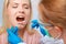 Dentist at work on woman patient in office