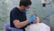 Dentistry clinic focused dentist in protective mask checking teeth of young patient