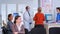 Dentistry doctor talking with senior woman standing in reception area