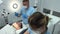 dentistry trainees learning to brush teeth close-up microscope camera floats by filming 2 young people who put a lip and