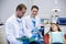 Dentists checking the reports while patient lying on dental chair