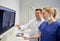 Dentists with x-ray on monitor at dental clinic