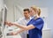 Dentists with x-ray on monitor at dental clinic