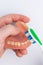 Denture in man hand cleaning with tooth brush closeup top view