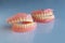 The dentures of the two elderly people were placed on a shiny white table