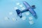 Departing blue plane on a blue background. Plane with ideas. Aircraft with cargo and information. View from above