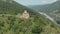 Departure on the dune around the ancient dilapidated Christian church standing high on the mountain. Erial View. North