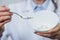 Dependence on drugs and medicines in modern times: hand of a young woman with a spoon of tablets taken from a plate