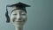 A depiction of a jubilant human (head)sculpture wearing a graduation cap, symbolizing the completion of education