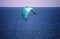 DEPLOYED TURQUOISE KITE SURFER SAIL OVER THE BLUE OCEAN OFF THE COAST AT UMHLANGA ROCKS, KWA-ZULU NATAL, SOUTH AFRICA