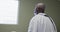 Depressed african american senior male patient looking out of the window at hospital