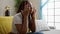 Depressed african american woman with braids sitting alone on sofa at home, unhappy expression reveals headache ache and stress