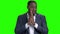 Depressed Afro-American businessman on green screen.