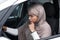 Depressed attractive islamic african american woman driver in hijab driving car, stop and waiting for movement