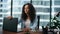 Depressed businesswoman opening laptop starting work in company office close up.