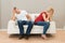 Depressed couple sitting on sofa