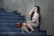 Depressed and desperate Asian Chinese businesswoman crying alone sitting on street staircase suffering stress and depression