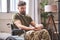 Depressed ex-serviceman sitting in a wheelchair and taking prescribed pills