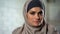 Depressed female in hijab looking sadly in camera, feeling hurt, abused woman