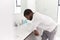 Depressed Man Leaning On Sink In Bathroom Looking Unhappy