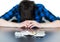 Depressed man taking drugs. Young man sitting on a table, drugs and pills in front of him