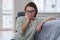 Depressed mature woman sitting on the floor at home