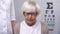 Depressed old woman in eyeglasses on ophthalmologist appointment, vision problem