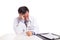 Depressed sad matured Asian doctor seated behind desk