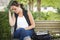 Depressed Scared Young Woman Sits on Bench at Park